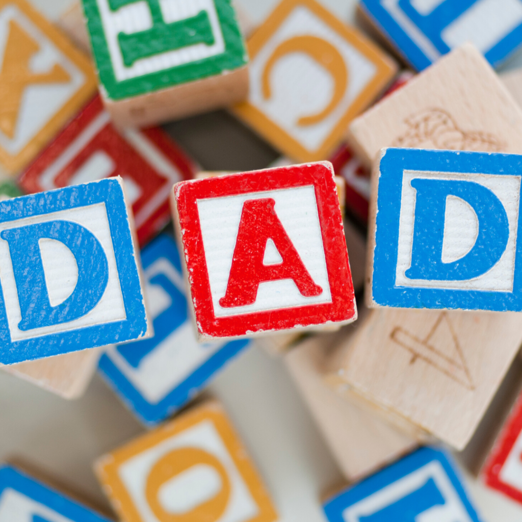 Image of children's blocks that spell Dad, describing the free printable Father's day coloring page.