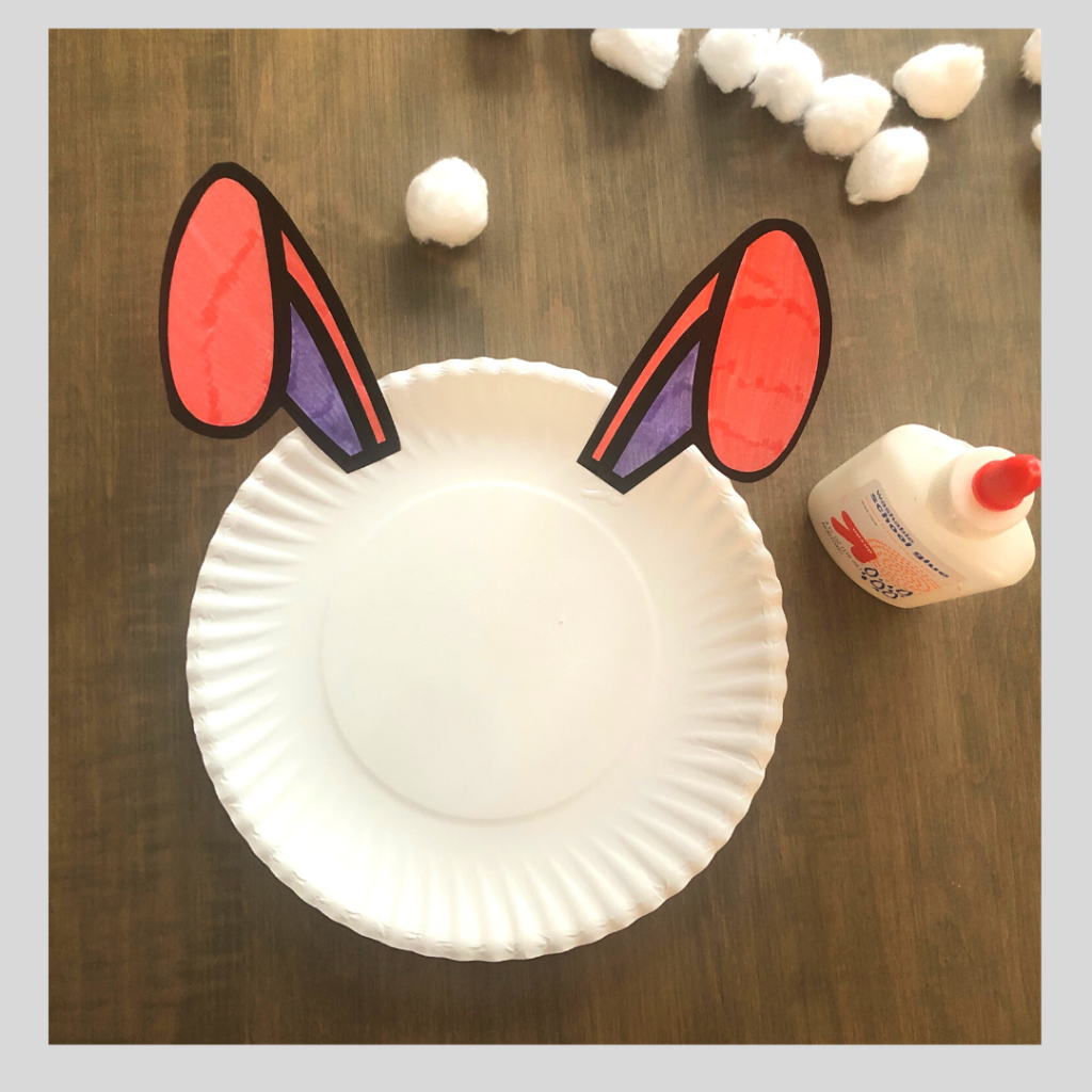 Glue the bunny ears on the paper plate craft.